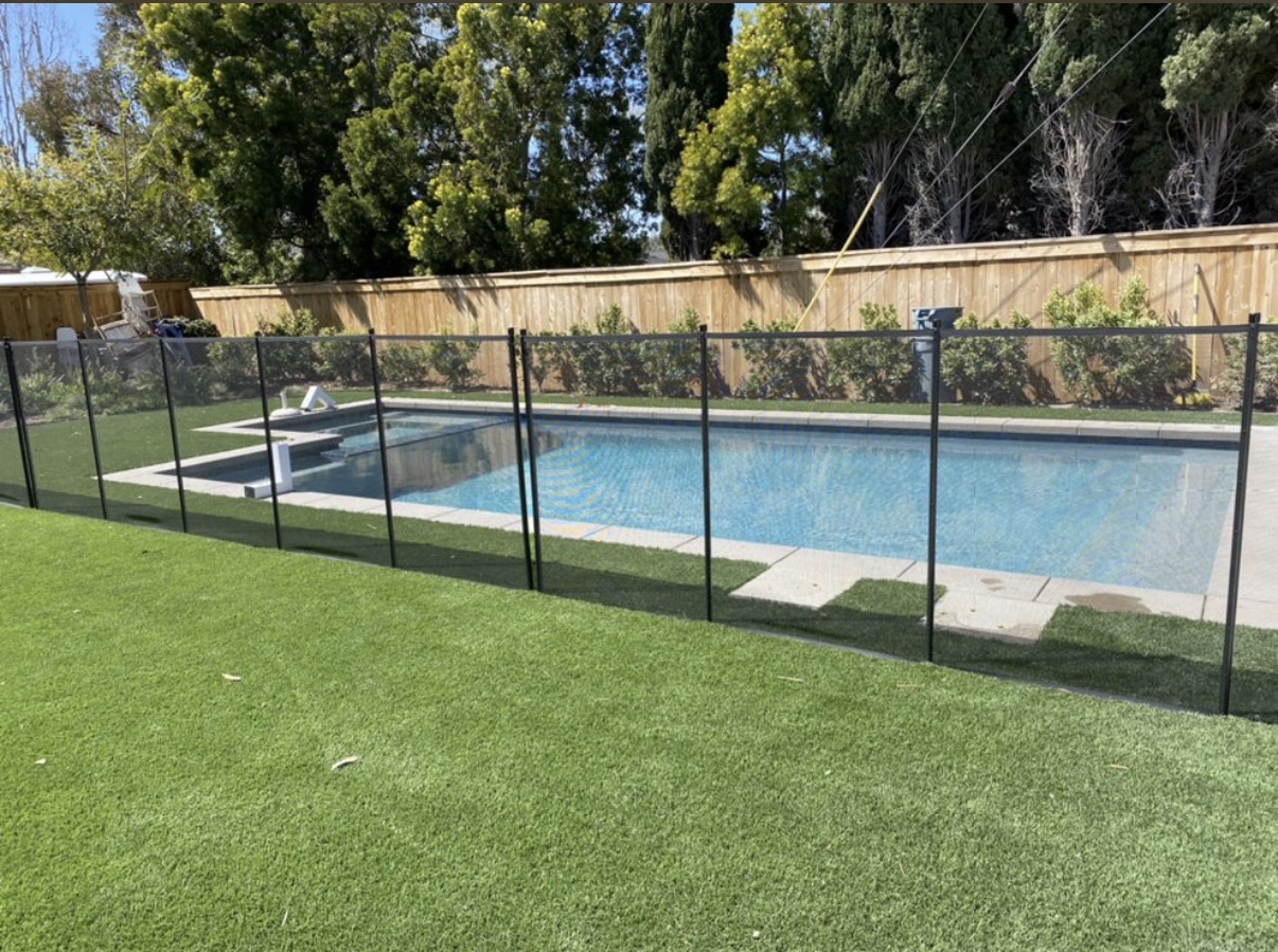 Backyard pool with black mesh fence
