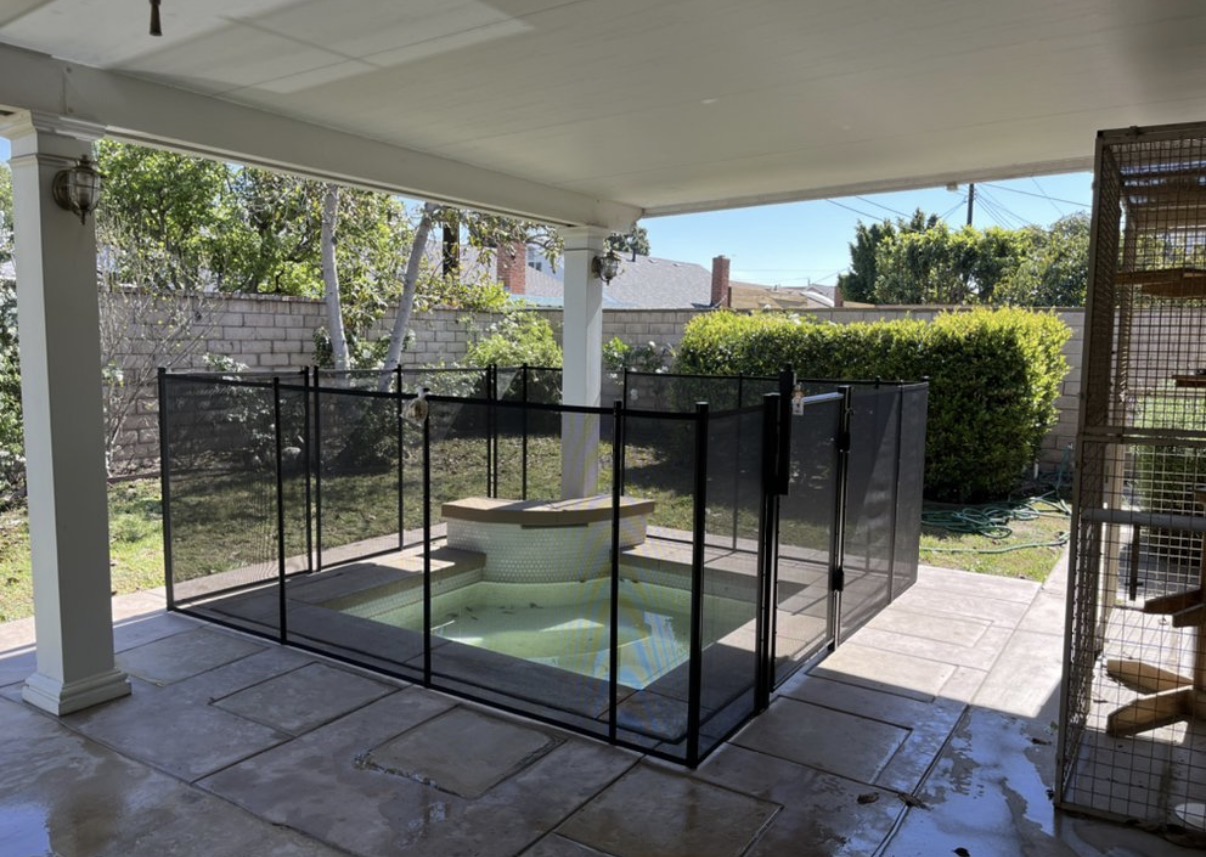 Covered patio spa with safety fence