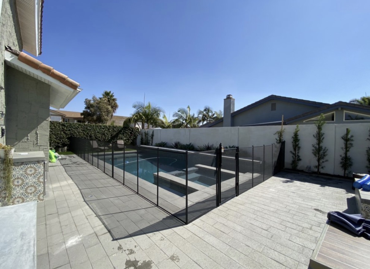 Modern courtyard pool with black mesh fence