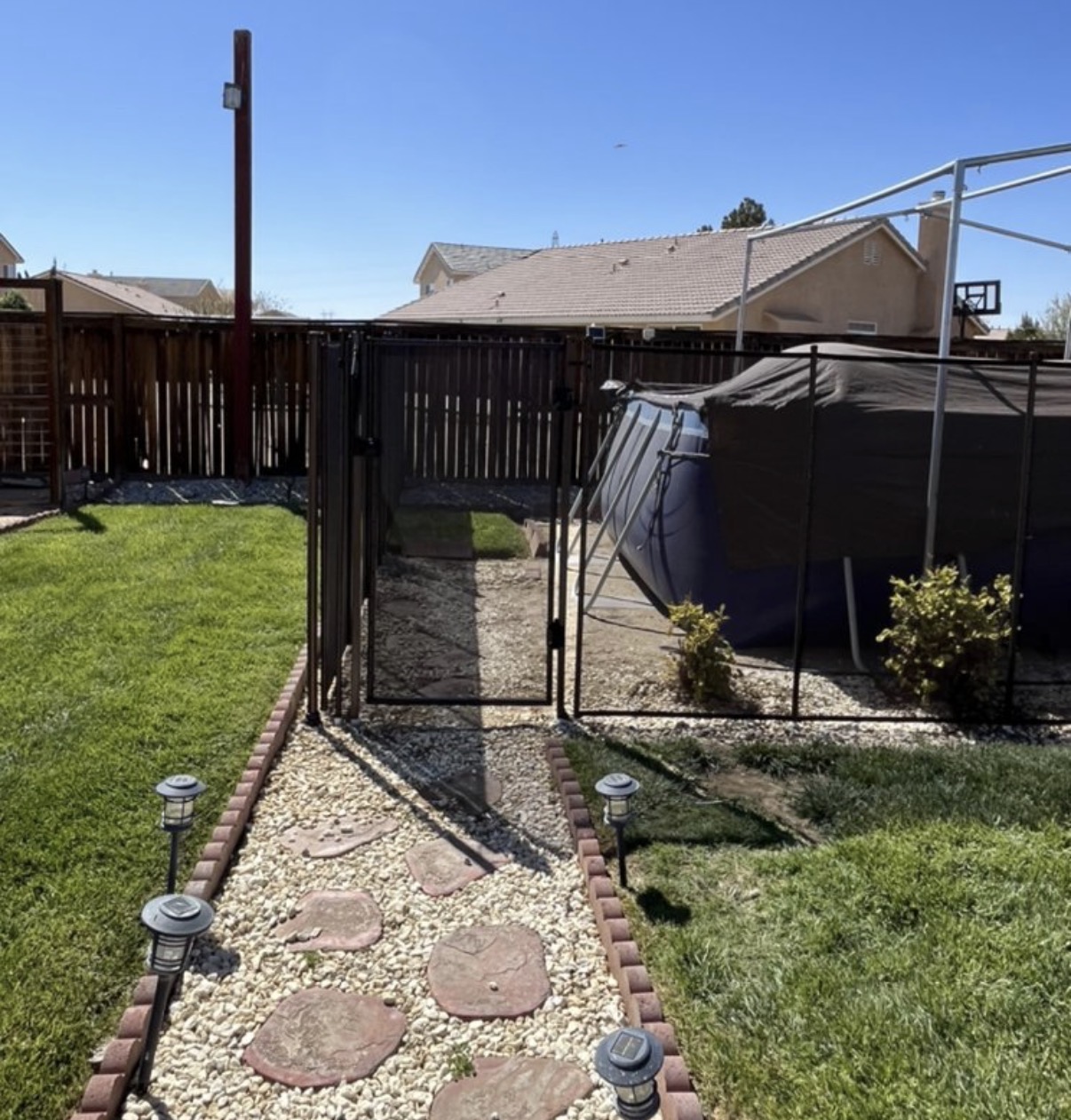 Side yard safety gate with stone walkway