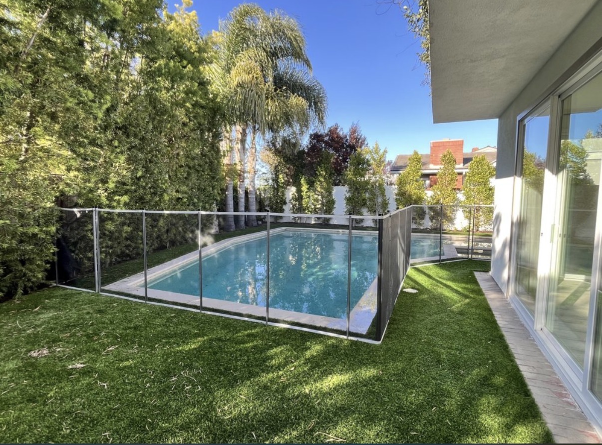 Rectangular pool with silver mesh safety fence